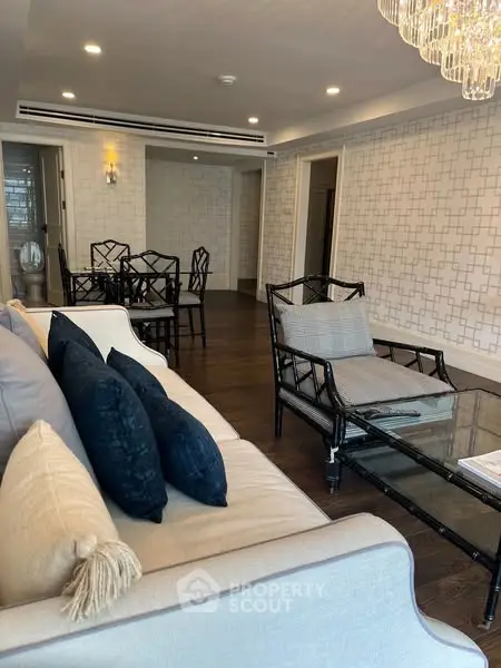 Elegant living room with modern furniture and stylish decor, featuring a cozy seating area and dining space.