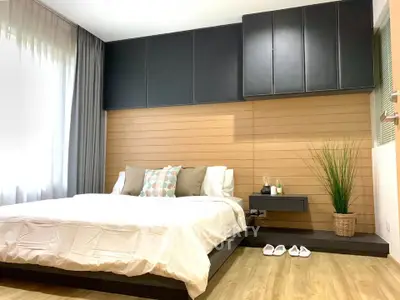 Modern bedroom with stylish decor and ample natural light