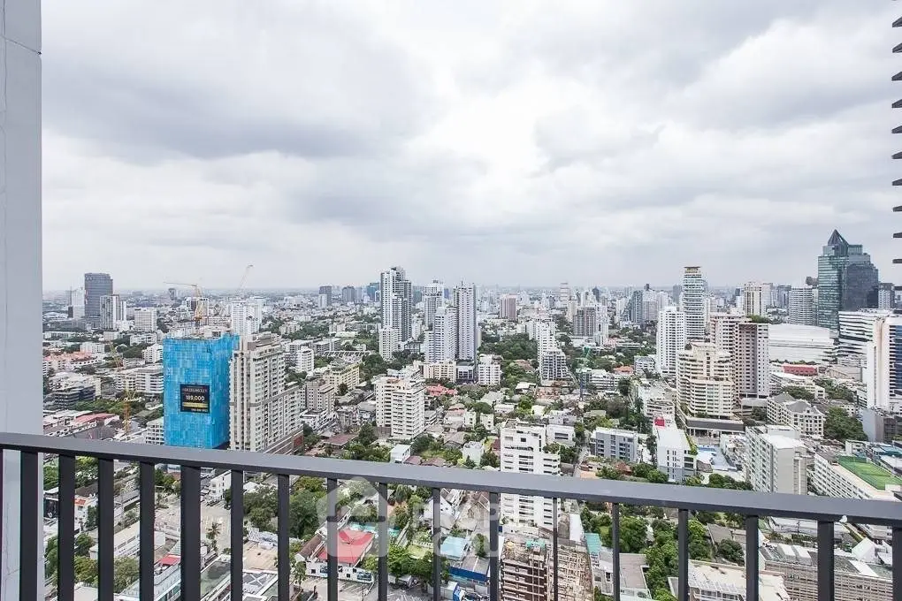 Stunning cityscape view from a high-rise balcony overlooking urban skyline.