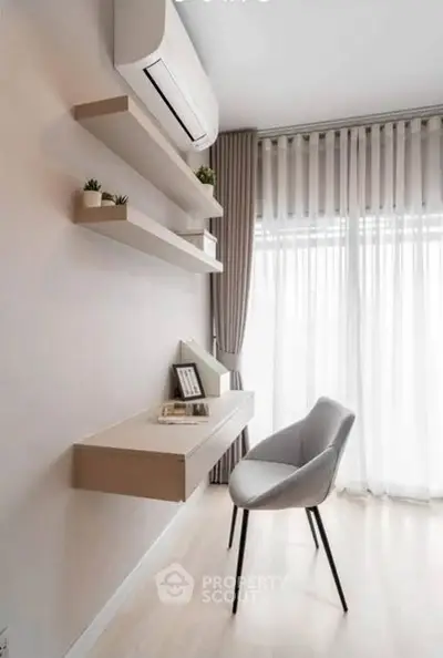 Modern study area with sleek desk, chair, and shelves in bright room with large window.