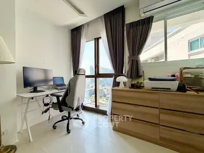 Modern study room with city view, featuring sleek desk and ergonomic chair.