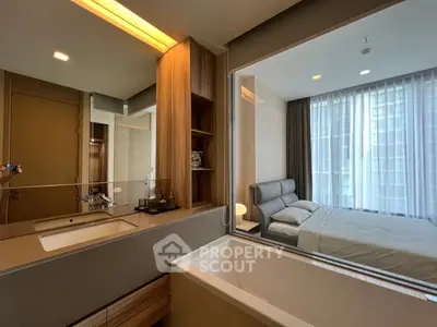 Modern bedroom with ensuite bathroom featuring a sleek bathtub and stylish decor.