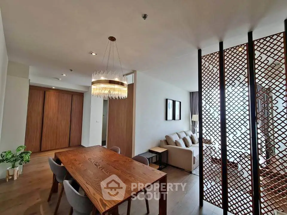 Elegant modern living room with wooden accents and stylish chandelier