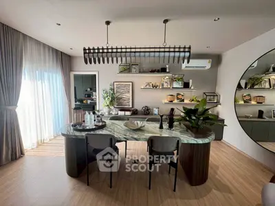 Luxurious modern kitchen with marble island and stylish decor in a spacious open layout.