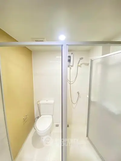 Modern bathroom with glass shower enclosure and sleek fixtures