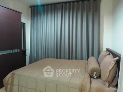 Cozy bedroom with elegant drapes and plush bedding, perfect for restful nights.