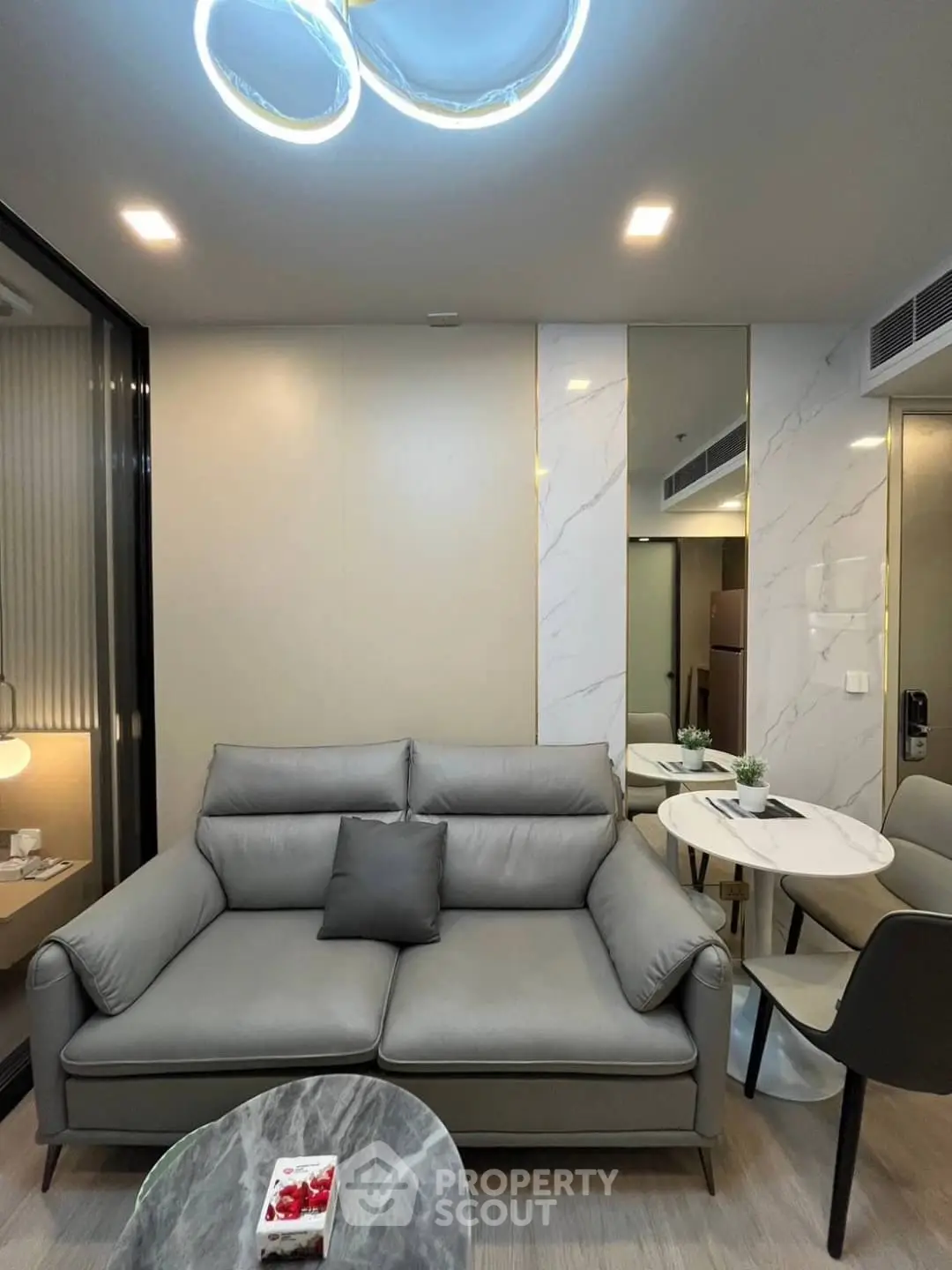 Modern living room with sleek furniture and stylish lighting in a contemporary apartment.