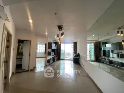 Spacious modern living room with large windows and elegant lighting