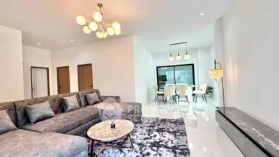 Spacious modern living room with elegant chandelier and cozy seating area