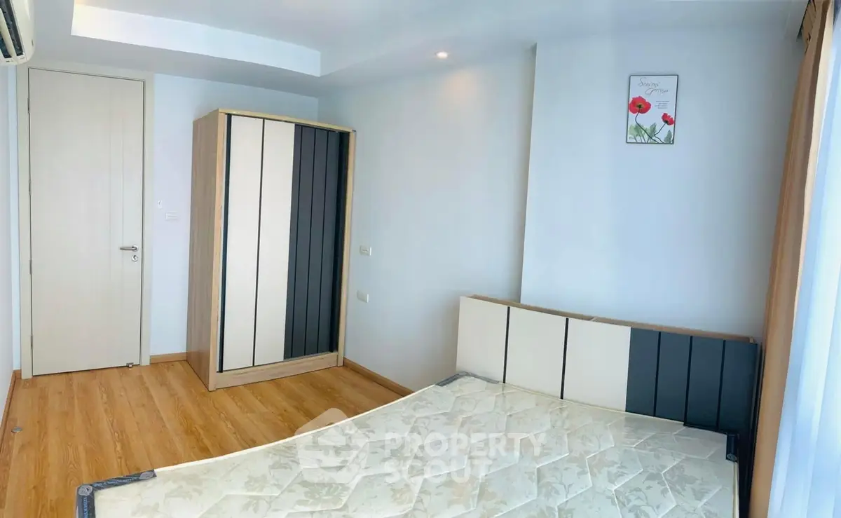 Modern bedroom with minimalist design and wooden flooring