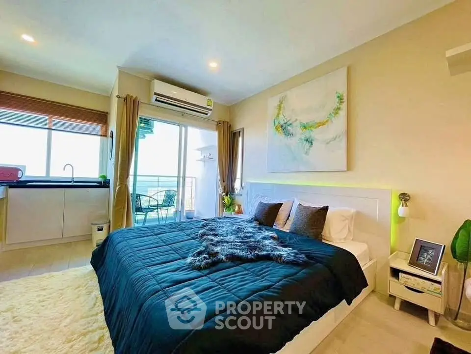 Modern bedroom with balcony access and stylish decor in a bright apartment.