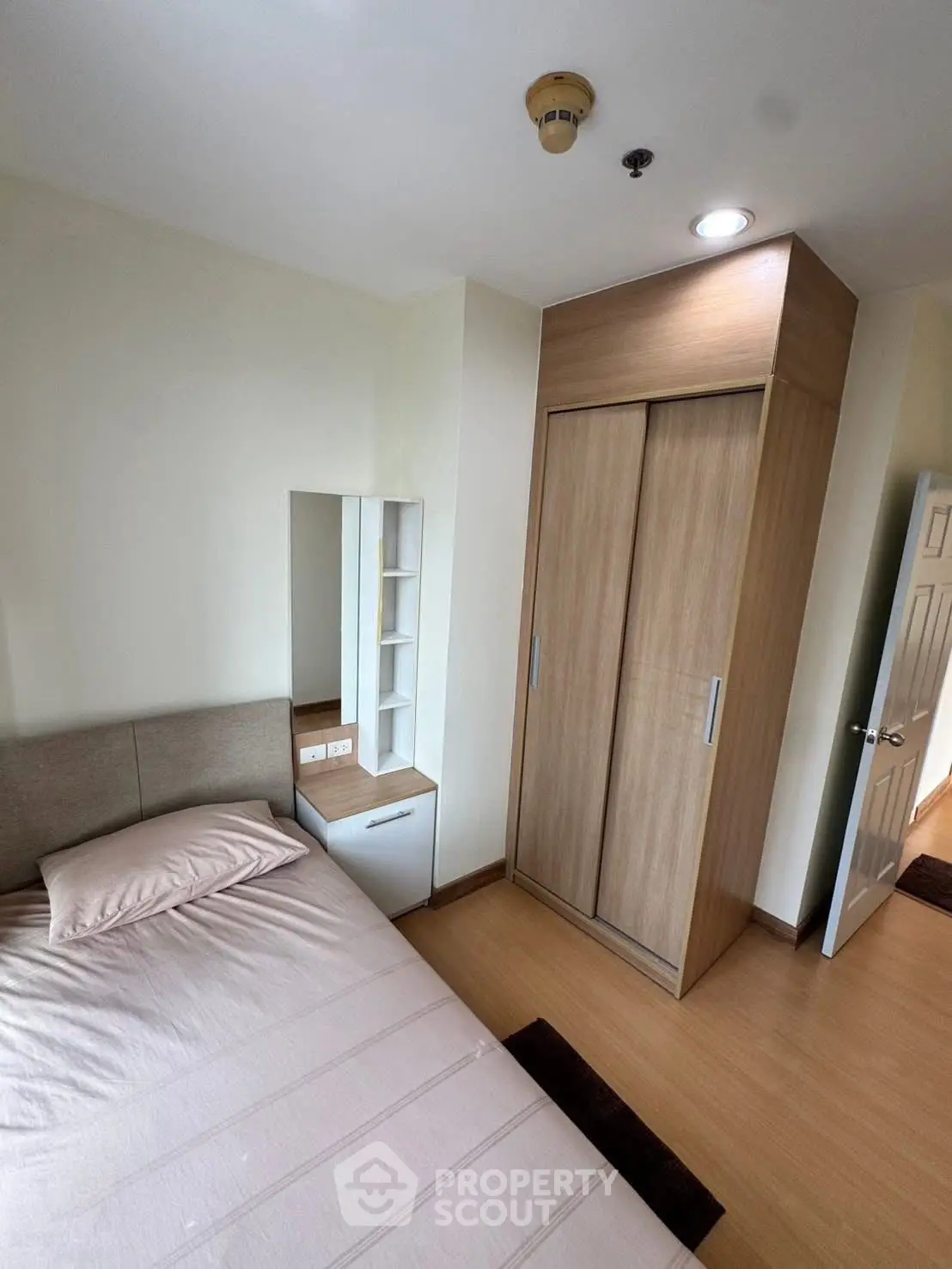 Cozy bedroom with modern wardrobe and stylish decor in a contemporary apartment.