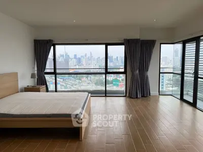 Spacious bedroom with stunning city view and large windows