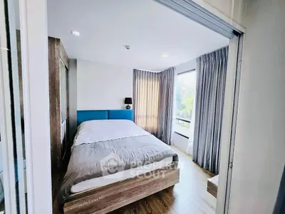 Modern bedroom with large window and stylish decor