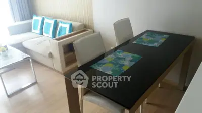 Modern living room with sleek dining table and cozy sofa