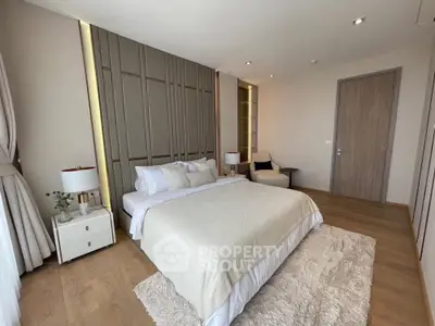 Luxurious bedroom with elegant decor and cozy ambiance, featuring a plush bed and stylish furnishings.