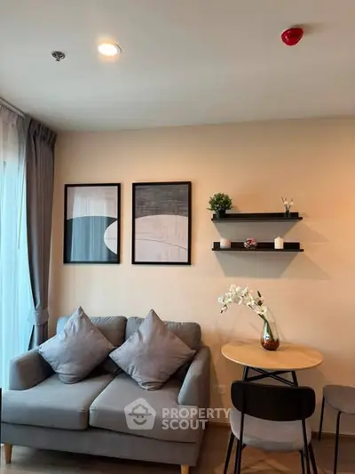 Cozy living room with modern decor and natural light, featuring a stylish sofa and elegant wall art.