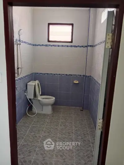 Spacious bathroom with modern tiling and shower, ideal for comfort and style.