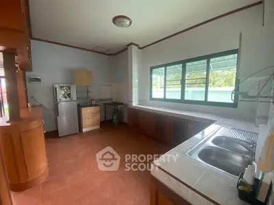 Spacious kitchen with ample counter space and large windows for natural light.