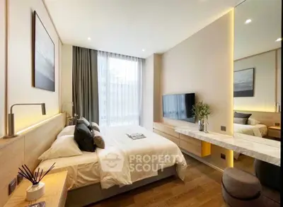 Modern bedroom with stylish decor, large window, and wall-mounted TV in a luxurious apartment.
