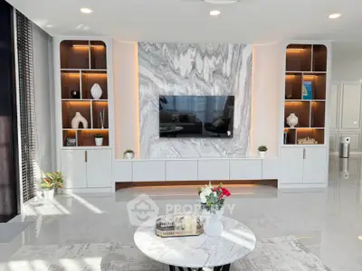 Luxurious modern living room with marble accents and built-in shelving