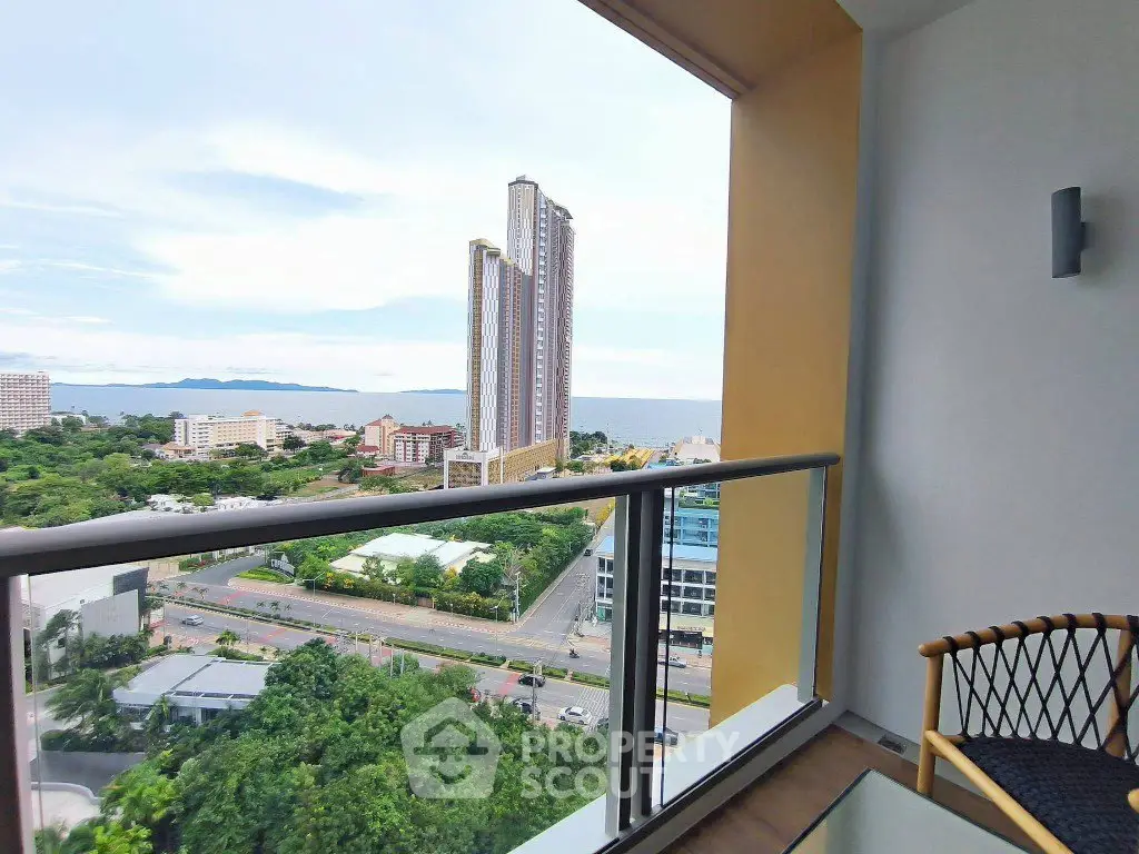 Stunning high-rise balcony view overlooking cityscape and ocean, perfect for urban living.