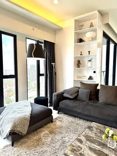 Stylish modern living room with large windows and cozy seating area