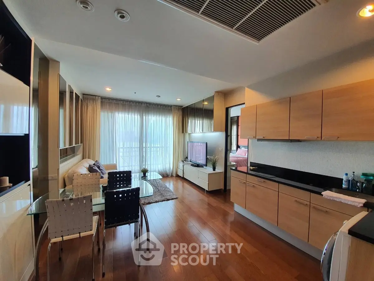 Spacious open-plan living room with modern kitchen and elegant decor