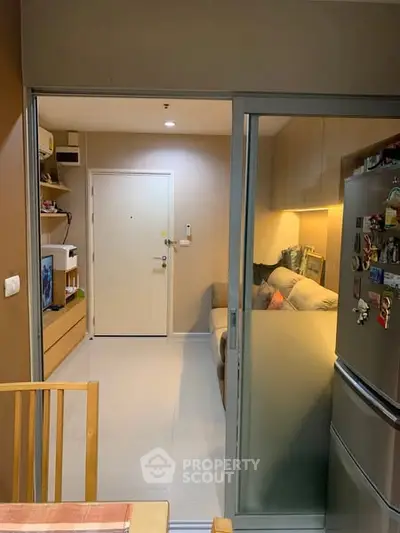 Cozy modern apartment with open layout and stylish decor, featuring a compact kitchen and inviting living area.