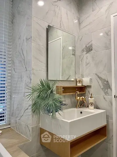 Modern bathroom with sleek marble tiles and stylish vanity