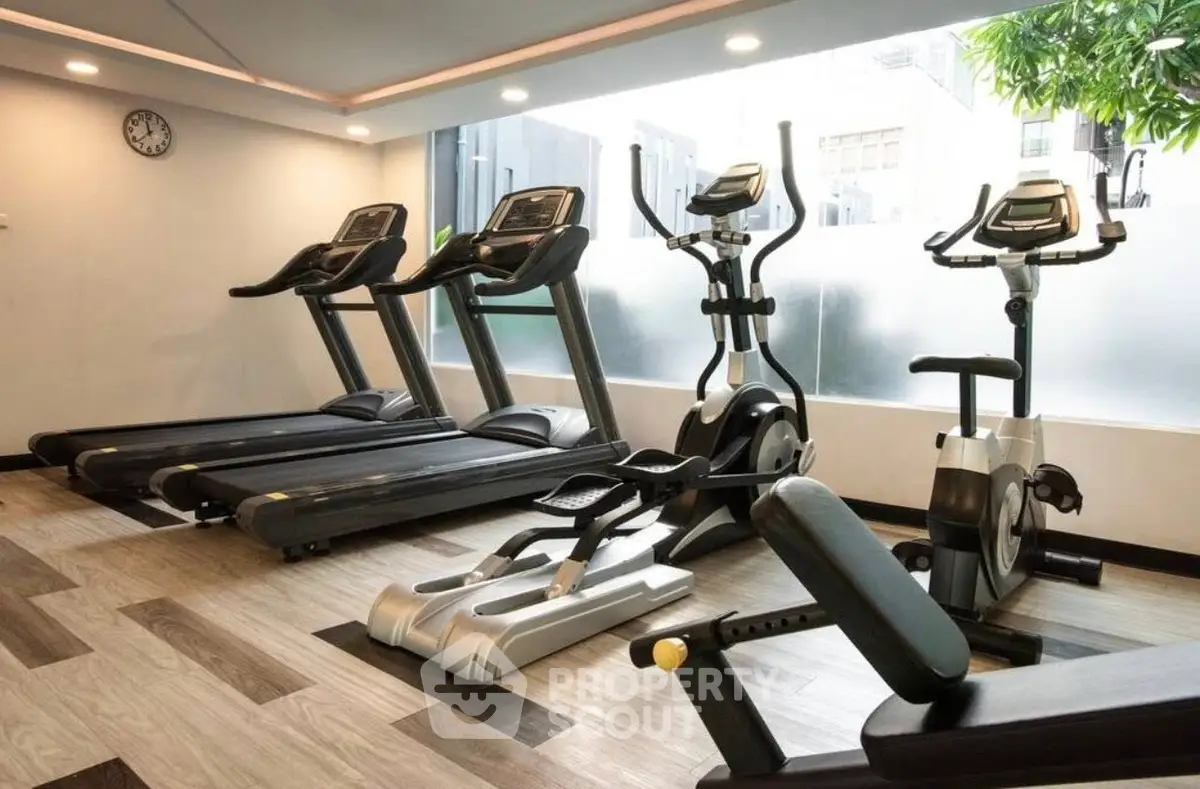 Modern gym with state-of-the-art equipment in a luxury residential building.