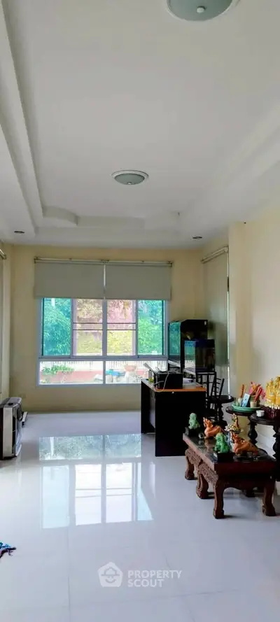 Spacious living room with large windows and elegant decor