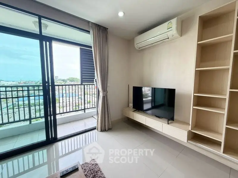 Modern living room with balcony and stunning city view, featuring sleek furniture and ample natural light.