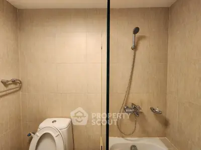 Modern bathroom with shower and bathtub in beige tile design