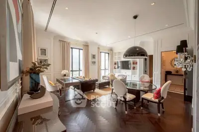 Luxurious living room with elegant decor and large windows offering natural light.