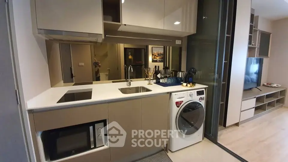 Modern kitchen with built-in appliances and sleek cabinetry in a stylish apartment.