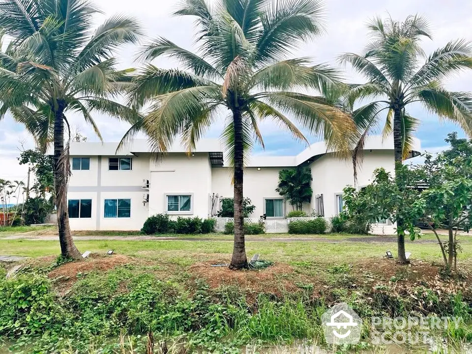 Stunning tropical property with lush greenery and palm trees, perfect for serene living.