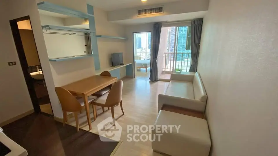 Modern living room with dining area and balcony view in urban apartment