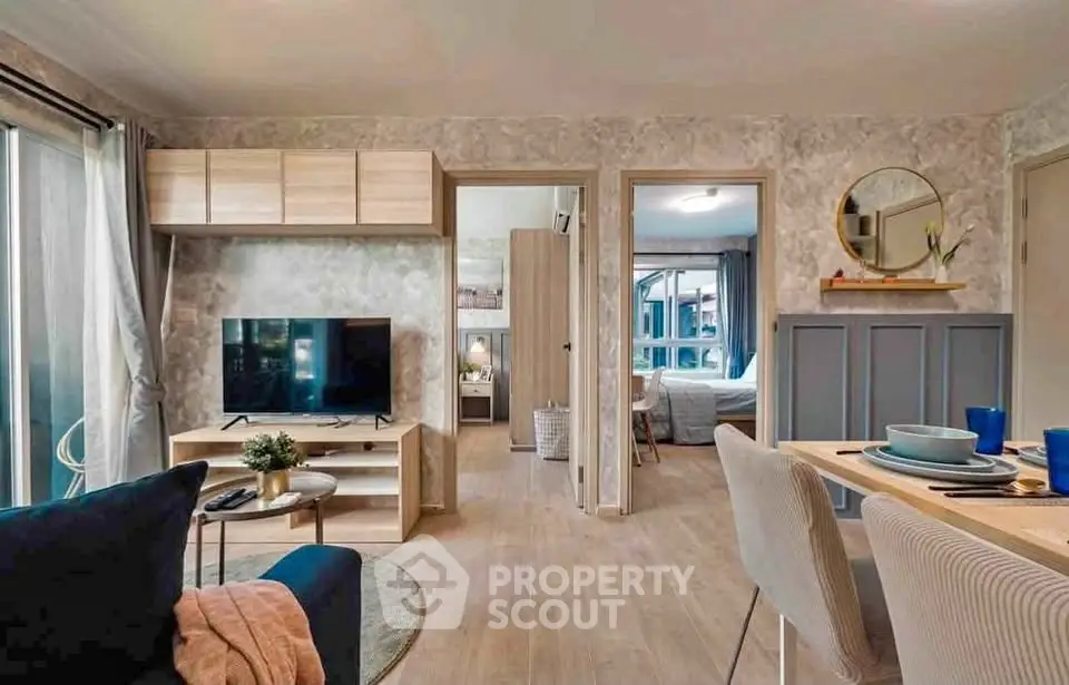 Modern open-plan living room with stylish decor and dining area, featuring a cozy ambiance and natural light.
