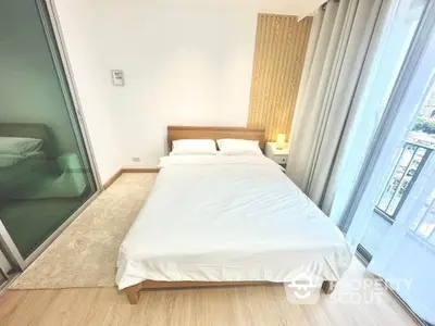 Modern bedroom with wooden accents and city view balcony