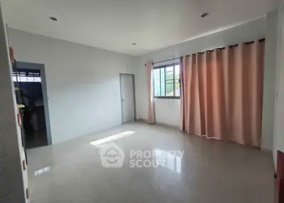 Spacious unfurnished room with large window and pink curtains, perfect for customization.