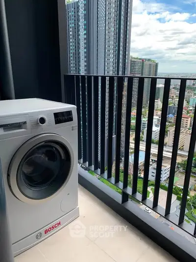 Modern balcony with washing machine and stunning city view in high-rise apartment.