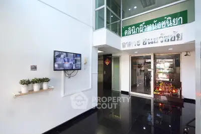 Modern commercial building interior with CCTV and glass entrance