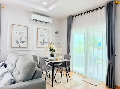 Elegant living room with stylish decor and natural light, featuring a cozy dining area and modern furnishings.