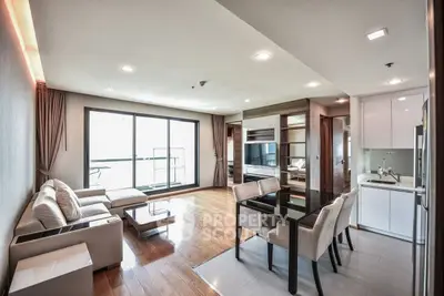 Spacious modern living room with open kitchen and elegant dining area in luxury apartment.