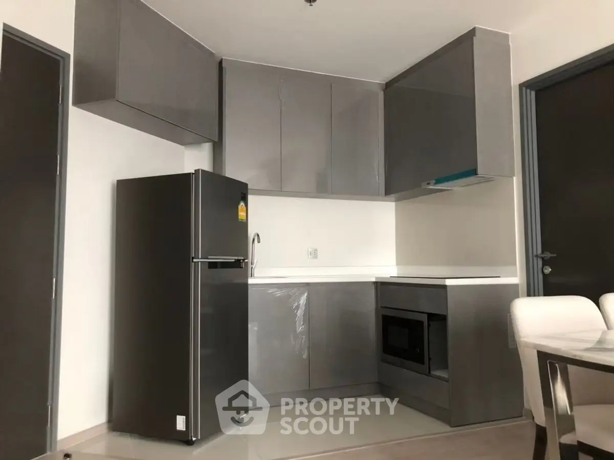 Modern kitchen with sleek grey cabinets and stainless steel appliances