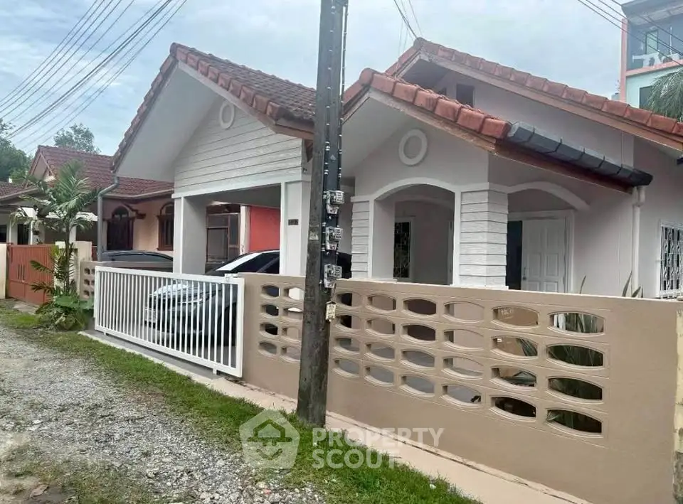 Charming suburban house with a fenced yard and carport, ideal for family living.