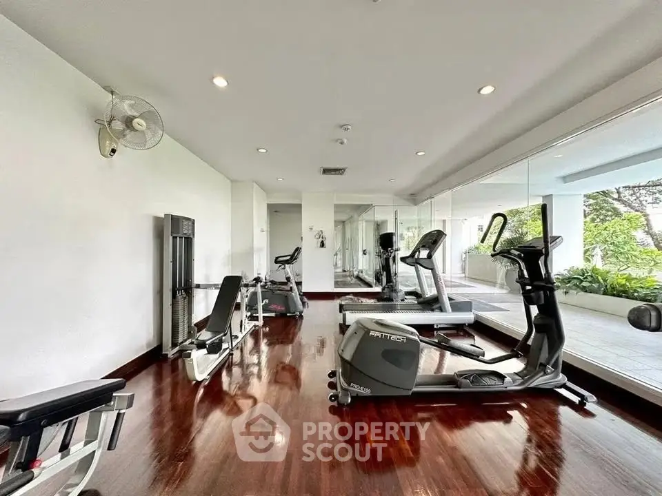 Spacious home gym with modern equipment and mirrored walls