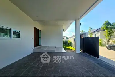 Modern home entrance with sleek design and spacious driveway