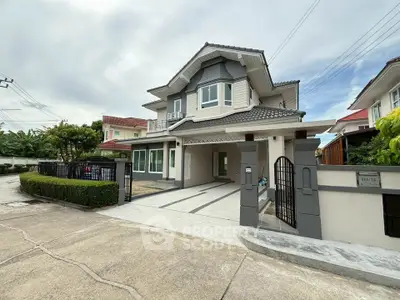 Charming two-story house with modern design and spacious driveway in a serene neighborhood.